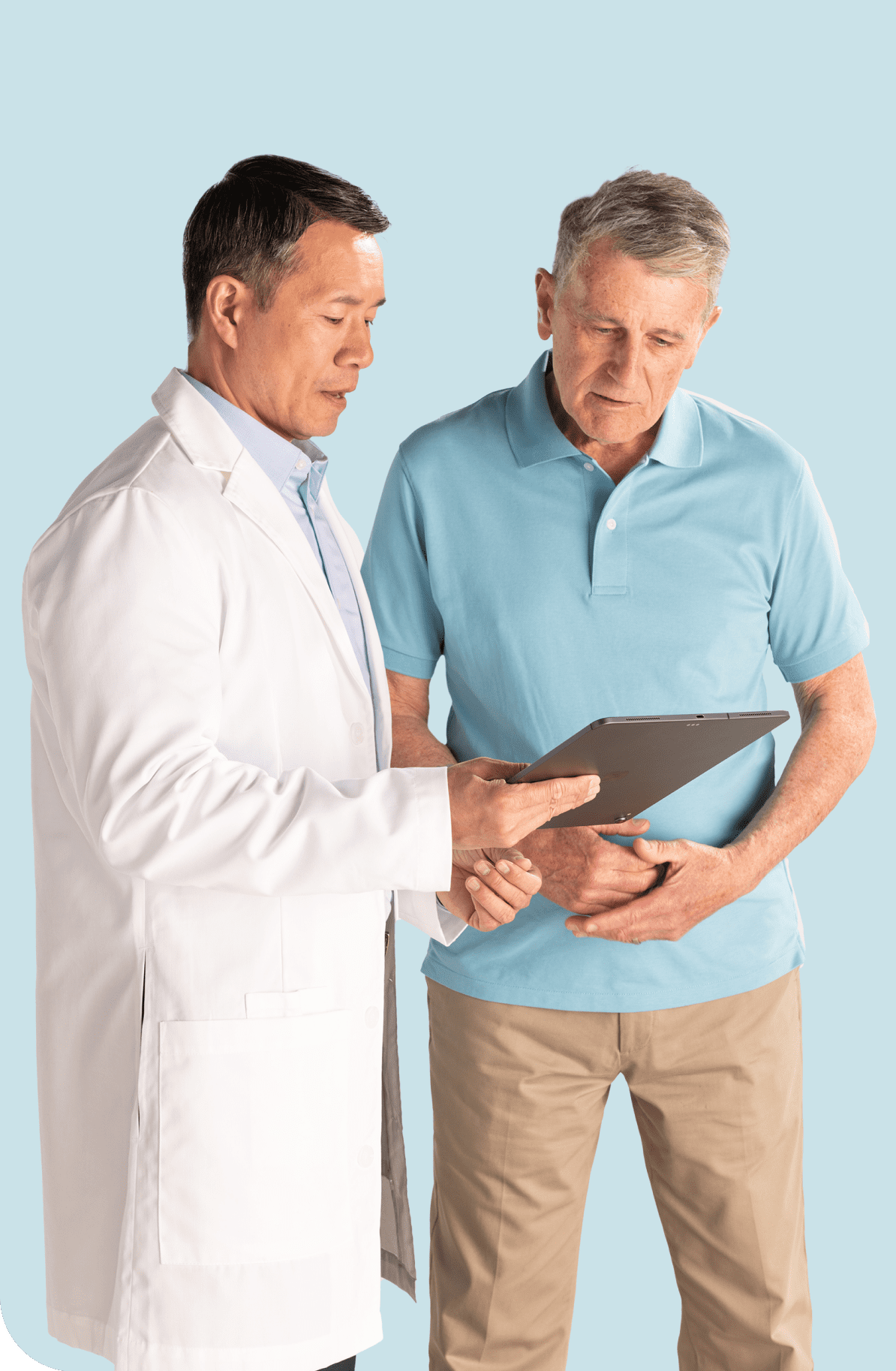 Doctor talking to a patient with a clipboard in his hand